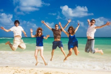 Healthy, Happy People jumping up in the air at Beach.